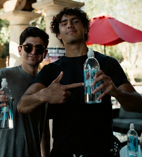 Two friends posing with AquaFlo bottles